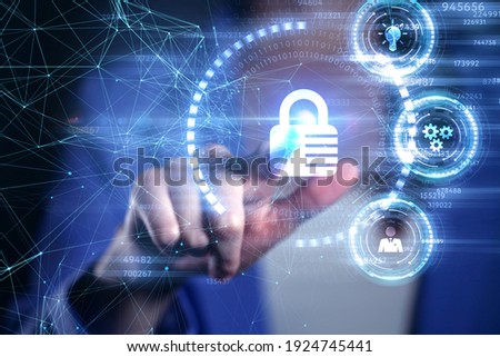 Cyber security data protection business technology privacy concept. Young businessman  select the icon security on the virtual display.