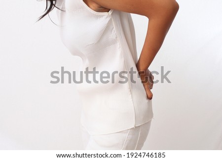 Close up photo of Tired woman feeling neck pain, massaging tense muscles. back pain and lower back view