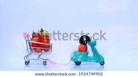 Design a motorbike pulling a shopping cart with tomatoes concept of fresh vegetable delivery service