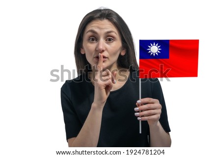 Happy young white woman holding flag of Republic of China and holds a finger to her lips isolated on a white background.