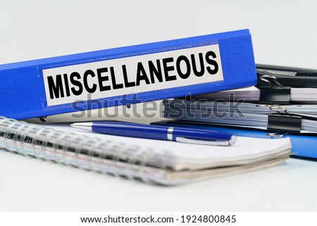 Business and finance concept. On the table are a notebook, a pen, documents and a folder with the inscription - MISCELLANEOUS Royalty-Free Stock Photo #1924800845