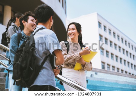 Happy Teenager Students talking and Walking On Stairs  Royalty-Free Stock Photo #1924807901