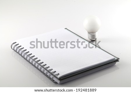 Notebook and bulbs isolate on white background