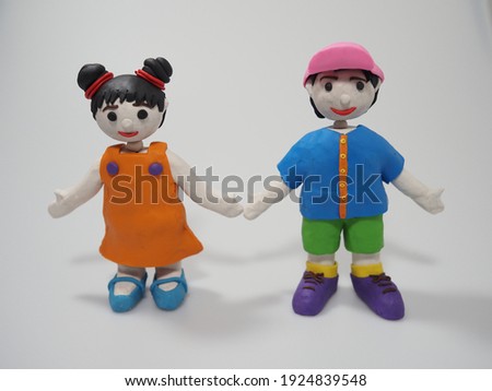 Boy and girl, cartoon figure, sculpted from plasticine, stand together, can be used as a model for sculpture not reserved.