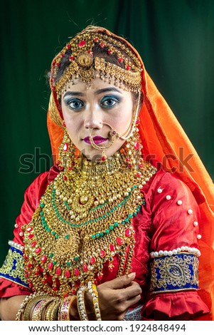    Portrait of beautiful Indian folk dancer close up view with traditional dress and jewelry 
