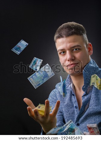 Business man with money bills flying around