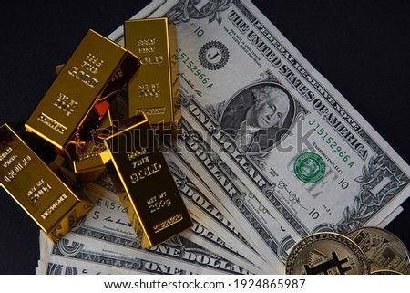Gold bars and American one dollar bills. Scattered bitcoin digital cryptocurrency coin. Bank image and photo background.