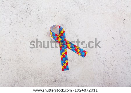Autism awareness symbol - ribbon with colorful jigsaw pattern. World Autism spectrum disorder Awareness Day, pride, jigsaw. White background. Copy space
