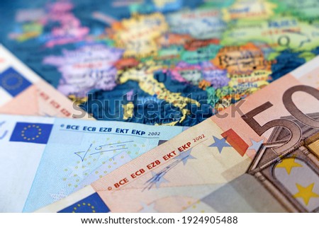 Euro banknotes on the Europe map. Concept of Eurozone, European economy, stock market in EU Royalty-Free Stock Photo #1924905488