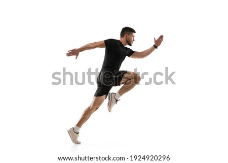 In jump. Caucasian professional sportsman training isolated on white studio background. Muscular, sportive man practicing. Copyspace. Concept of action, motion, youth, healthy lifestyle. Royalty-Free Stock Photo #1924920296