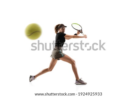 Catching. Young caucasian professional sportswoman playing tennis isolated on white background. Training, practicing in motion, action. Power and energy. Movement, ad, sport, healthy lifestyle concept