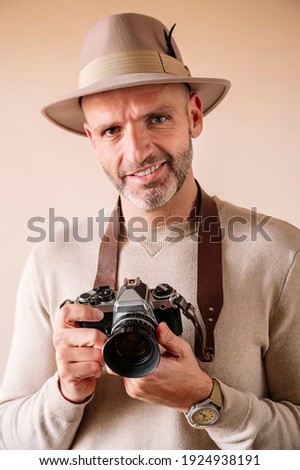 45 year old man with analog camera