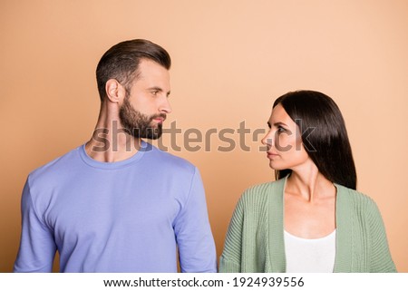 Profile photo of optimistic nice couple look each other wear sweater isolated on beige color background