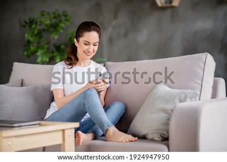Full size portrait of attractive positive person sit hold phone blogging typing post comment free time weekend indoors