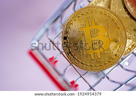 Crypto currency Golden Bitcoins in a shopping cart close-up
