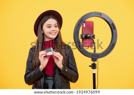 influencer. happy teen girl use selfie led. kid beauty blogger. childhood happiness. cheerful child do makeup. vlogger with cosmetics. video blog on smartphone. blogging light lamp. weblog and vlog. Royalty-Free Stock Photo #1924976099