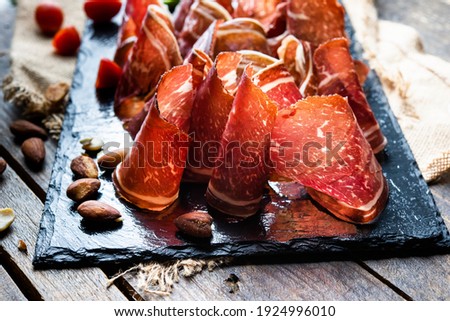 Typical dried spanish meat, beef meat, tapa de  cecina de León Royalty-Free Stock Photo #1924996010