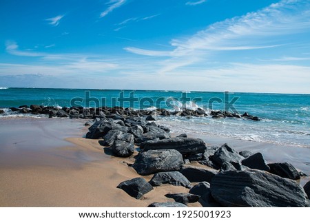 Rocks which make a line between land and sea