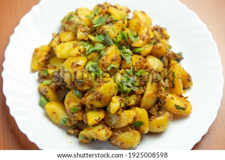 Indian Nepali Style Aloo or Alu Fry Recipe served on a plate. Potato Fry, Boiled and fried potato recipe.Selective focus Royalty-Free Stock Photo #1925008598