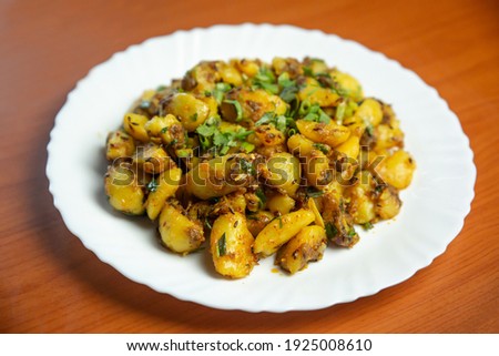 Indian Nepali Style Aloo or Alu Fry Recipe served on a plate. Potato Fry, Boiled and fried potato recipe.selective focus Royalty-Free Stock Photo #1925008610