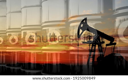 Crude mining concept and graph of falling oil prices on the trading exchange. Crude oil pump jack at oilfield on sunset backround. Fossil crude output and fuels oil production. Oil drill rig