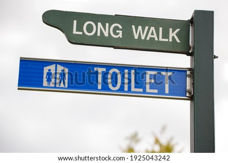 Long walk and toilet sign with female and male icons, in Adelaide, South Australia 