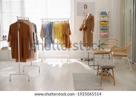 Stylish women's clothes and accessories in modern boutique Royalty-Free Stock Photo #1925065514