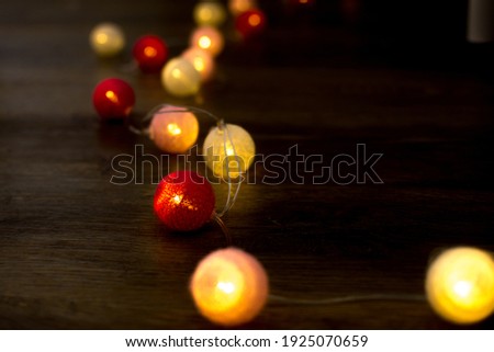 Red and pink christmas ball background. New year lightening on the wooden floor. Decoration and celebration concept.