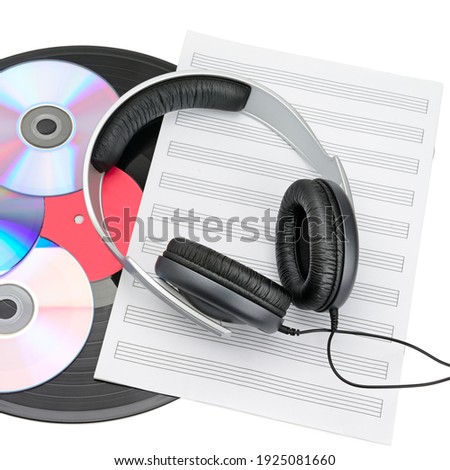 Stereo headphones, CDs and retro vinyl disc isolated on white background. Modern and retro musical equipment.
