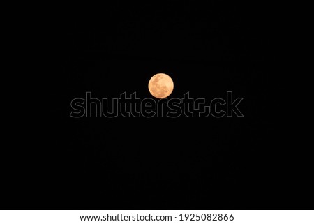 Red moon in night sky 