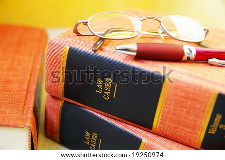 Closeup of law books, glasses and pen