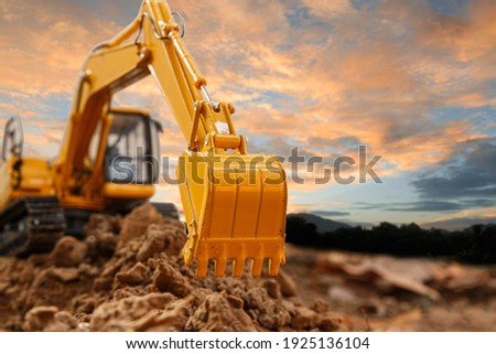 Excavator with Bucket lift up are digging the soil in the construction site on the sky  background Royalty-Free Stock Photo #1925136104