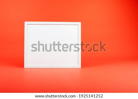 white square frame with mock up on orange background.