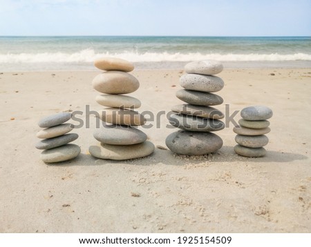 Stone family on the beach, represent father, mother and two children.