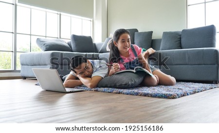 Asian father and his daughter spending time together at home, selective focus