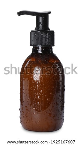 Dispenser bottle with water drops isolated on white. Men's cosmetics