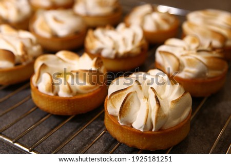 Tart with meringue on a dark background. Top view. Side view. Professional dessert.