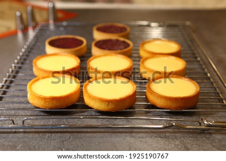The tart cooking process, dessert in the oven, baking of tarts. Side view, top view. Professional dessert making process.