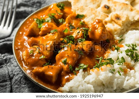 Homemade Indian Butter Chicken with Rice and Naan Bread Royalty-Free Stock Photo #1925196947