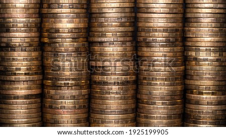 Full-screen background of stacks of abstract yellow brass coins
