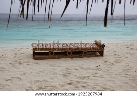 Maldives island beach. Tropical landscape of summer scenery, white sand with palm trees. Luxury travel vacation destination. Exotic beach landscape during the rain.