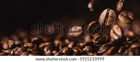 Brown Roasted Coffee Beans Closeup On Dark Background Royalty-Free Stock Photo #1925210999