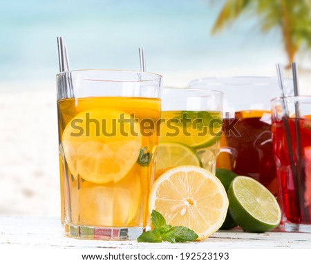 Grapefruits, lime and lemon, slice, mint ice tea on wooden background. Summer concept. Refresh drink.