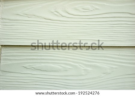  Artificial wood house wall close up photo caption with natural light at daytime that show their texture and surface.