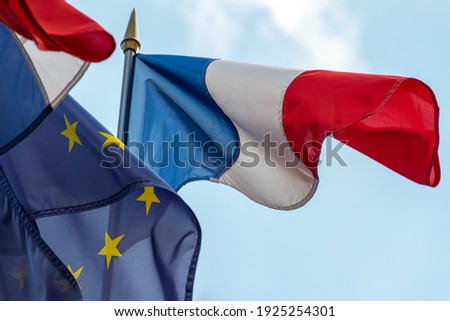France and Europe: French and European Union flags fluttering together in the wind. Close-up shot