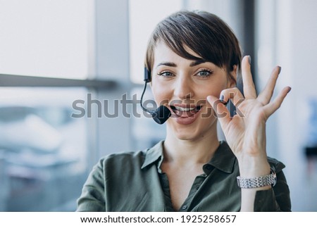 Young woman with microphone working on record studio