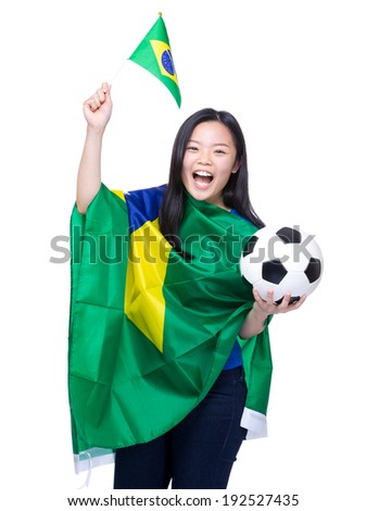 Excited soccer fans holding Brazil flag and football