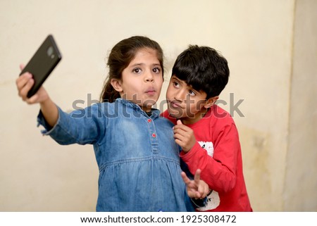 little friend taking selfie with smartphone