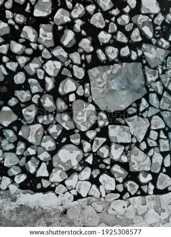 Drone images from air. Ice cover on Baltic sea is melting and lots of small ice pieces floating and drifting around. Calm ocean with lots of small icebergs drifting around. Drone photography from air