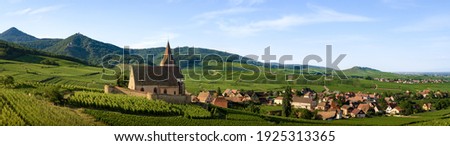 Summer sunset view of the medieval church of Saint-Jacques-le-Major in Hunawihr, small village between the vineyards of Ribeauville, Riquewihr and Colmar in Alsace, wine making region of France Royalty-Free Stock Photo #1925313365